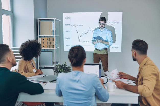 Architect and contractor reviewing structural plans at a construction site